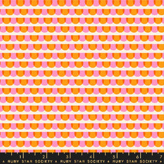 Pattern of pink and orange semicircles on an off-white background with ruler