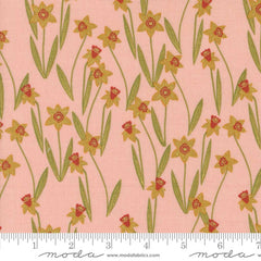 Pattern of yellow flowers with red centers on a pink background with ruler