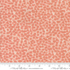 Pattern of small pink flowers on a pink background with ruler