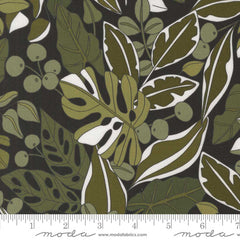Patterned fabric with green leaves and berries on a dark background with ruler