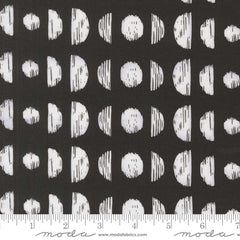 Pattern of white circles and semi-circles on a black background with ruler