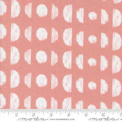 Pattern of white circles and semi-circles on a pink background with ruler