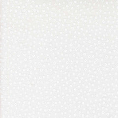 Patterned fabric with small white shapes on a light background