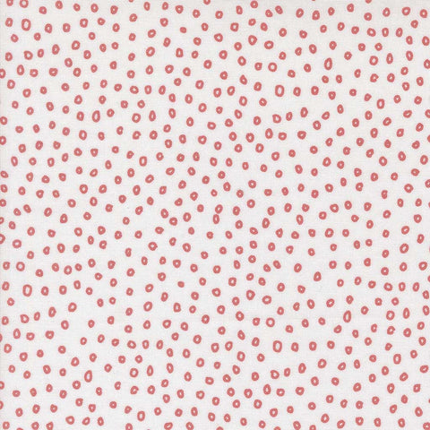 Patterned fabric with small red shapes on a white background