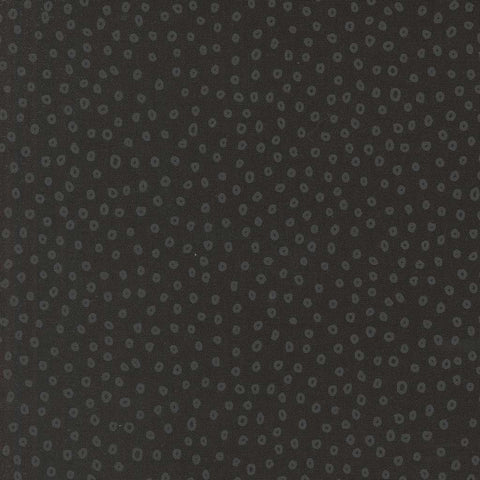 Patterned fabric with small gray shapes on a dark background