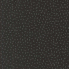 Patterned fabric with small gray shapes on a dark background