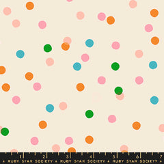 Pattern of colorful dots on an off-white background with ruler