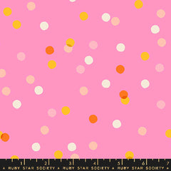 Pattern of colorful dots on a pink background with ruler