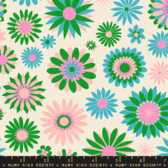 Pattern of green, blue, pink, and white flowers on an off-white background with ruler
