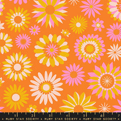 Pattern of yellow, pink, and white flowers on an orange background with ruler