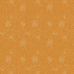 Pattern of small white and yellow metallic clusters of dots on a dark yellow background