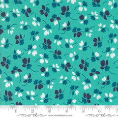 Floral pattern with small flowers on an aqua background with ruler
