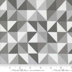 Geometric pattern of triangles in shades of gray and white with ruler