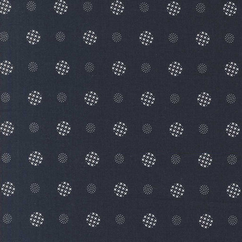 Patterned fabric with white geometric shapes on a indigo blue background
