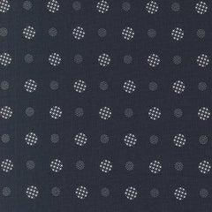 Patterned fabric with white geometric shapes on a indigo blue background