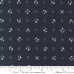 Patterned fabric with white geometric shapes on a indigo blue background with ruler