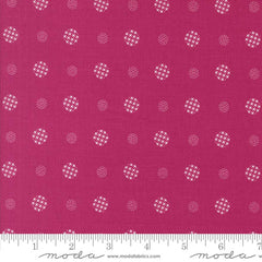 Patterned fabric with white geometric shapes on a magenta background with ruler