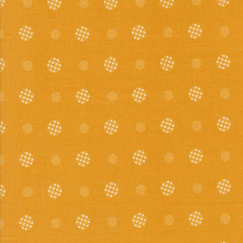 Patterned fabric with white geometric shapes on a yellow background