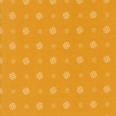 Patterned fabric with white geometric shapes on a yellow background