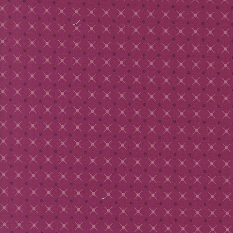 Patterned fabric with a geometric design on a magenta background