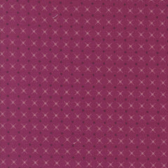 Patterned fabric with a geometric design on a magenta background