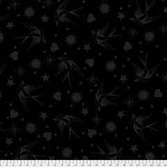 Pattern of gray birds, stars, hearts, and dots on a black background with ruler