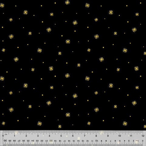 Metallic gold asterisk print on a black background with ruler