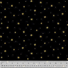 Metallic gold asterisk print on a black background with ruler