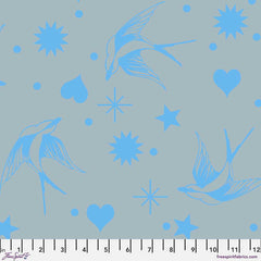 Pattern of blue birds, hearts, stars, and dots on a gray background with ruler