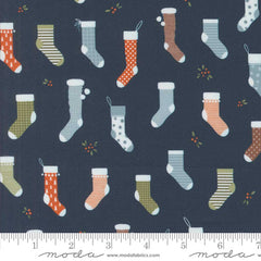 Pattern of colorful Christmas stockings on a dark blue background with ruler