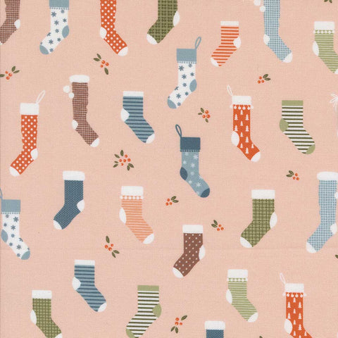 Pattern of colorful Christmas stockings on a pink background