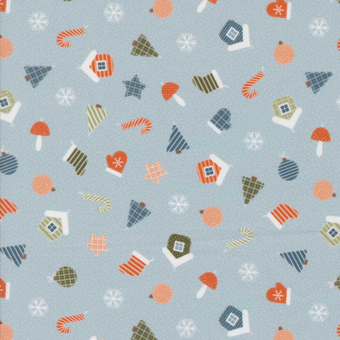 Patterned fabric with Christmas-themed elements on a light blue background