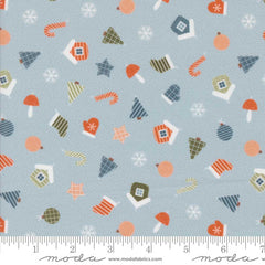 Patterned fabric with Christmas-themed elements on a light blue background with ruler