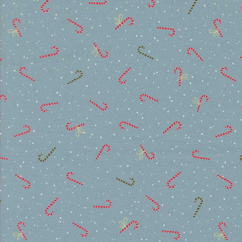 Pattern of red and green candy canes on a blue fabric background with white dots