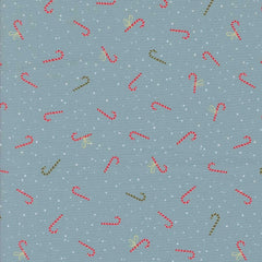 Pattern of red and green candy canes on a blue fabric background with white dots