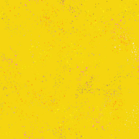 Pattern of multi-colored speckles on a yellow background