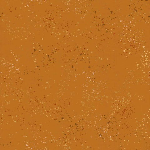 Pattern of multi-colored speckles on a light brown background