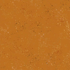 Pattern of multi-colored speckles on a light brown background