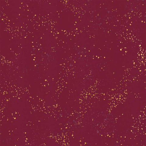 Pattern of multi-colored speckles on a dark red background