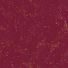 Pattern of multi-colored speckles on a dark red background