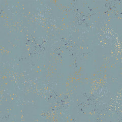 Pattern of multi-colored speckles on a light blue background