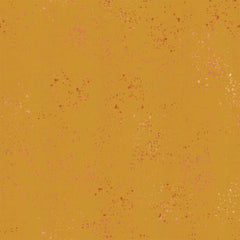 Pattern of multi-colored speckles on a gold background