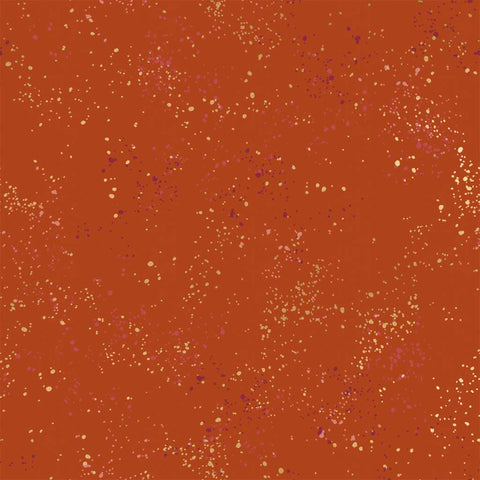 Pattern of multi-colored speckles on a dark orange background