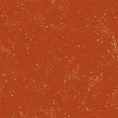 Pattern of multi-colored speckles on a dark orange background