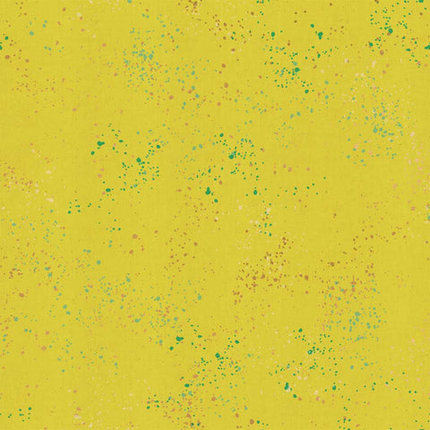 Pattern of multi-colored speckles on a yellow background