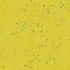 Pattern of multi-colored speckles on a yellow background