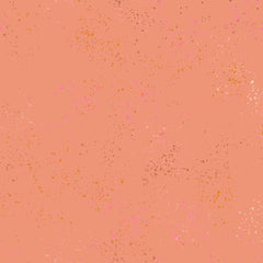 Pattern of multi-colored speckles on a peach background