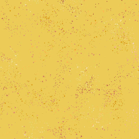 Pattern of multi-colored speckles on a yellow background