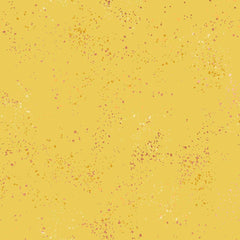 Pattern of multi-colored speckles on a yellow background