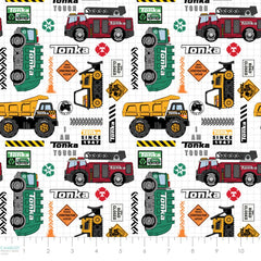 Pattern of Tonka trucks and construction vehicles on a white grid background with ruler